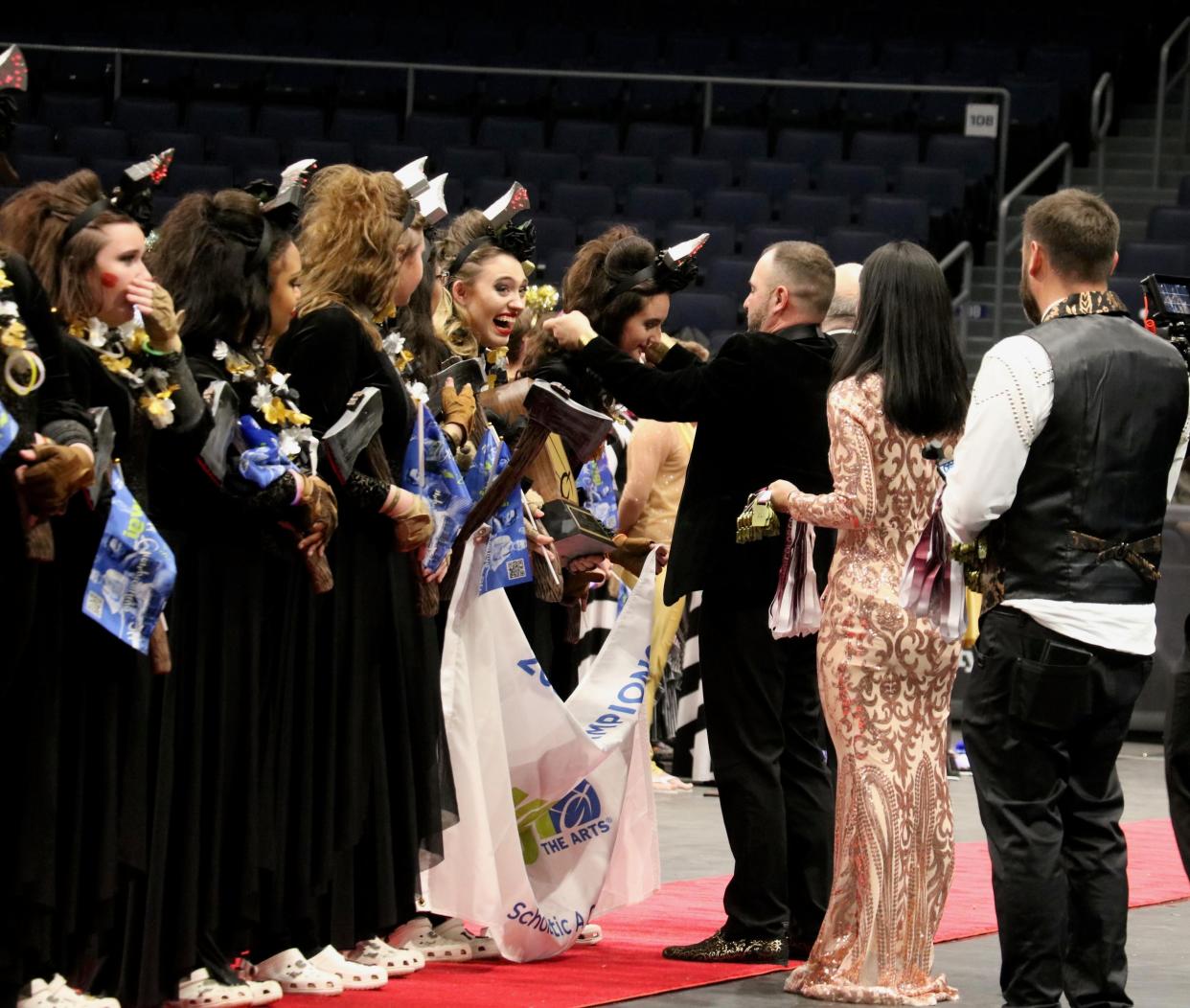 The Arlington High School winter guard receives gold medals after winning its division in the WGI Sport of the Arts world championships in Ohio on April 13, 2024.