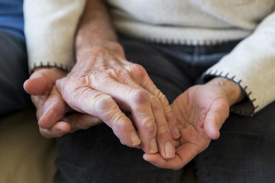 Gary Mund recently lost his wedding band, and his wife Tammie has to help him trim his fingernails.