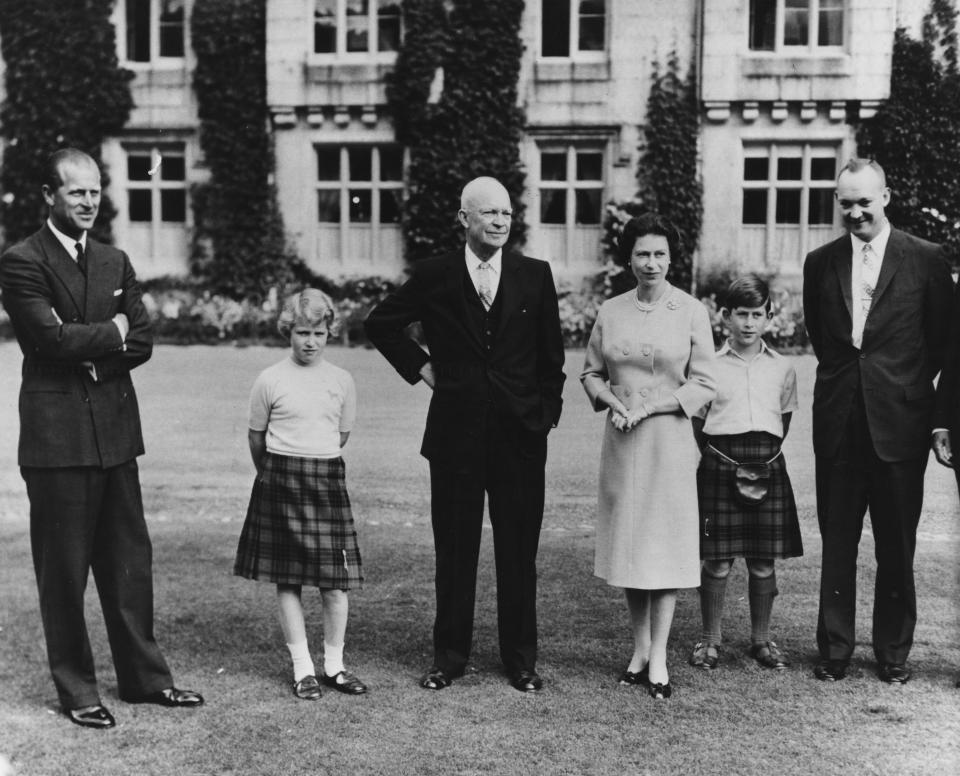 President Eisenhower (centre) with the British Royal family (L-R) Prince Philip, Princess Anne, HM Queen Elizabeth, Prince Charles and Captain John Eisenhower, at Balmoral Castle, Scotland, September 1959. / Credit: Fox Photos / Getty Images