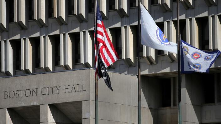 Boston City Hall with flags raised outside