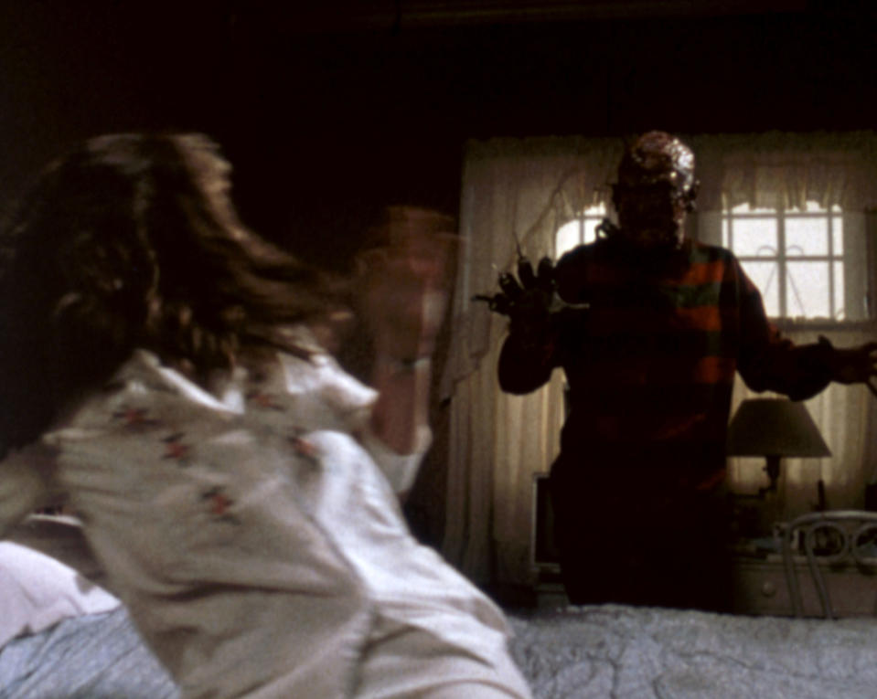 Freddy Krueger attacks a victim in her bed