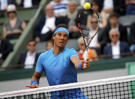 Rafael Nadal of Spain plays a shot to Quentin Halys of France during their men's singles match at the French Open tennis tournament at the Roland Garros stadium in Paris, France, May 26, 2015. REUTERS/Jean-Paul Pelissier