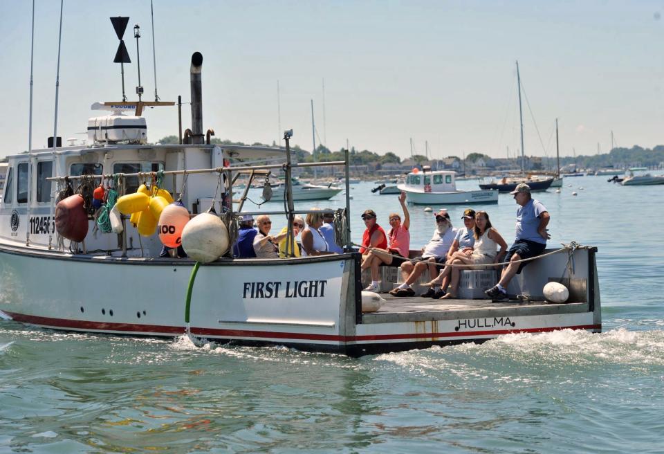 Veterans wave as they head out on a boat from the Nantasket Beach Salt Water Club for the blessing of the fleet, Saturday, June 25, 2022.