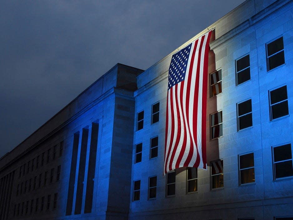 A memorial flag is illuminated near the spot where American Airlines Flight 77 crashed into the Pentagon on September 11, 2001.