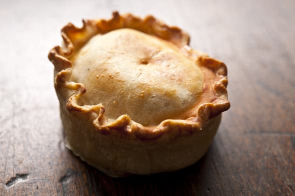 A handmade Pork Pie, shallow focus rustic style.Traditional British food.