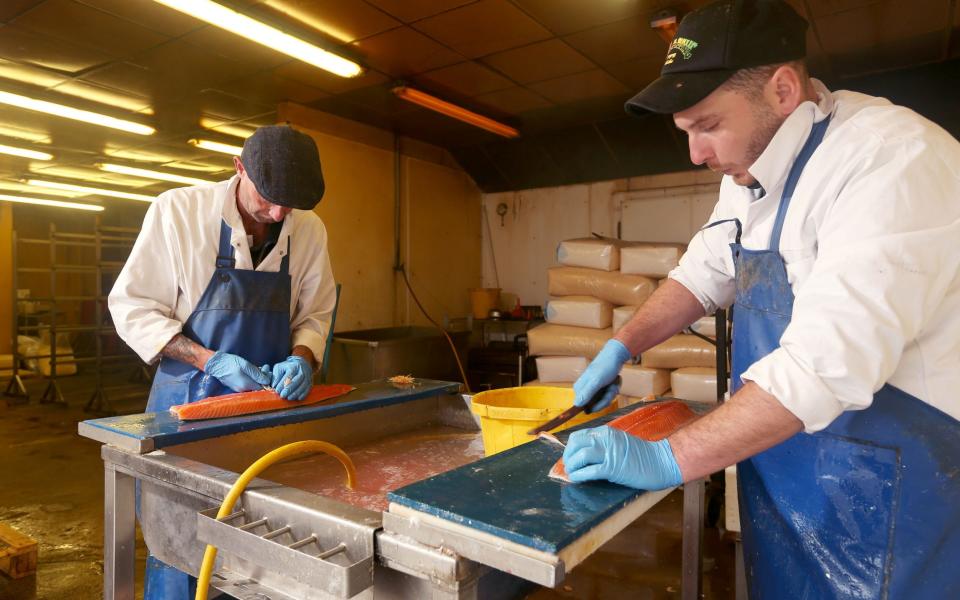 Andrew Clubley (left) and Bobby Moore filleting salmon at Alfred Enderby Ltd