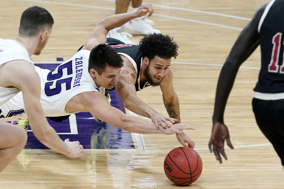 Northwestern guard Eric Zalewski, left, and Nebraska guard Kobe Webster battle for a loose ball during the first half of an NCAA college basketball game in Evanston, Ill., Sunday, March 7, 2021. (AP Photo/Nam Y. Huh)