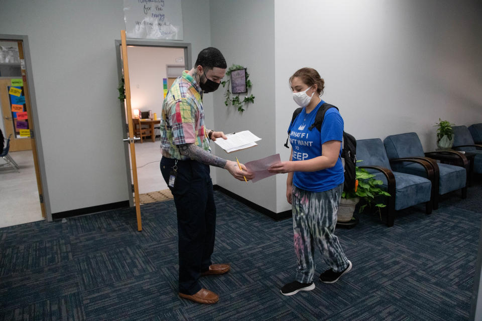 World history teacher Brandon Williams greets a student on the first day of school at Griffin Middle School Wednesday, August 11, 2021.