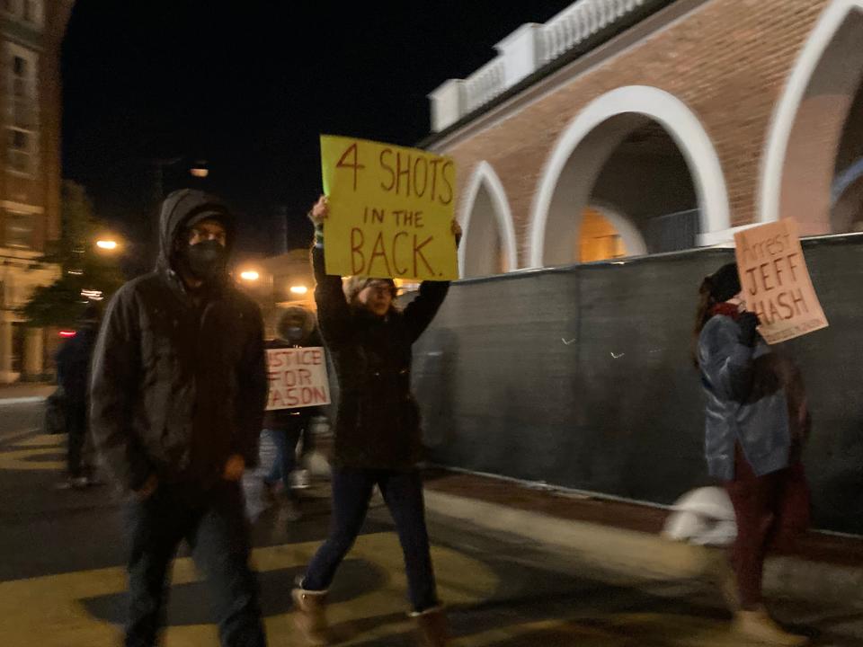 Protesters march around the Market House on Tuesday, Jan. 11, 2022, on the third night of protests on behalf of Jason Walker, an unarmed Black man shot by an off duty deputy.