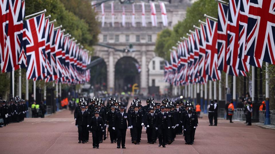 Metropolitan police officers are seen walking in formation down The Mall ahead of the State Funeral of Queen Elizabeth II on September 19, 2022, in London.