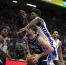 Philadelphia 76ers center Mo Bamba, top, fouls Sacramento Kings forward Domantas Sabonis (10) as he attempts a shot in the second half of an NBA basketball game in Sacramento, Calif., Monday, March 25, 2024. The Kings won 108-96. (AP Photo/José Luis Villegas)