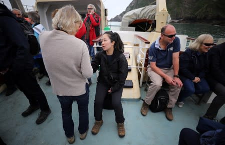 Reuters journalist Mari Saito talks to members of the Cloud Appreciation society during the ferry journey on Lundy Island