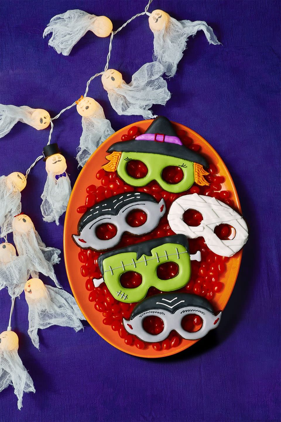 <p>These might look complicated but they aren't. Just make a batch of sugar cookie dough, then use a <a href="https://members.easypeasyandfun.com/downloads/halloween-printable-masks/" rel="nofollow noopener" target="_blank" data-ylk="slk:mask template;elm:context_link;itc:0;sec:content-canvas" class="link ">mask template</a> to carve out the shape of a witch, vampire, mummy, and Frankenstein.</p><p><a href="https://www.womansday.com/food-recipes/food-drinks/recipes/a12008/basic-sugar-cookies-recipe-wdy1212/" rel="nofollow noopener" target="_blank" data-ylk="slk:Get the Basic Sugar Cookies recipe;elm:context_link;itc:0;sec:content-canvas" class="link "><strong><em>Get the Basic Sugar Cookies recipe</em></strong></a>.</p>