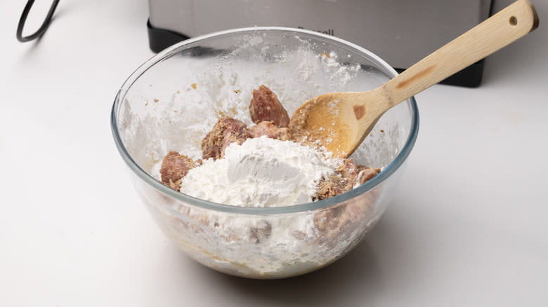 marinated pork coated in cornstarch in bowl