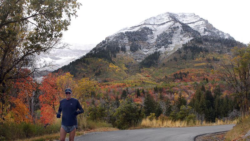 George McPheeters of the Sundance area in Provo Canyon jogs up the road past Sundance Resort with both winter and fall scenes for a beautiful backdrop, on Wednesday Sept. 30, 2009.
