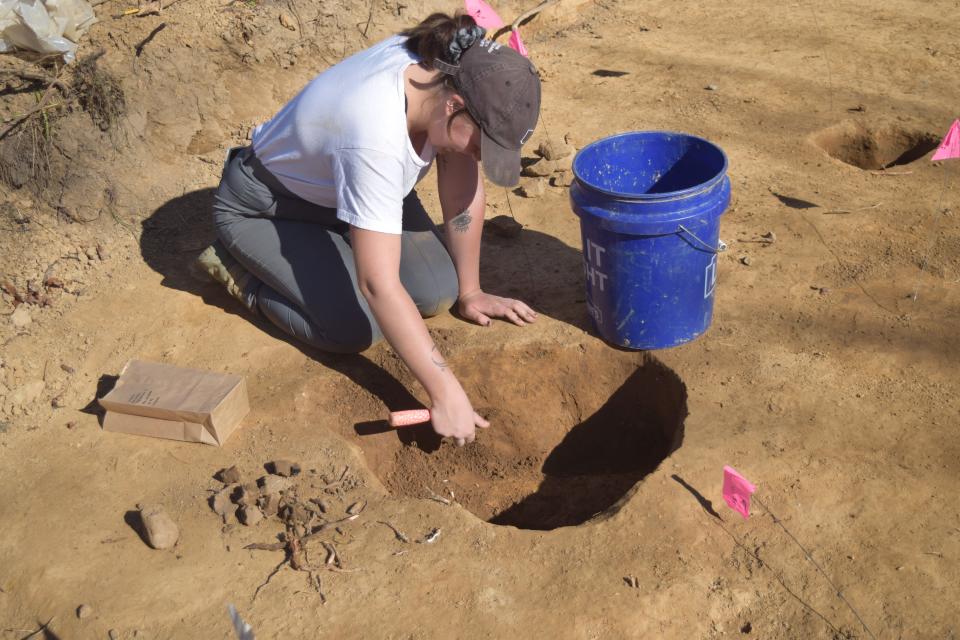 Katie Piatek of Lawhon & Associates in Columbus digs as part of an archaeological survey of the site where a new Thornwood Crossing roadway and roundabout will connect with Thornwood Drive, Reddington Road and River Road.