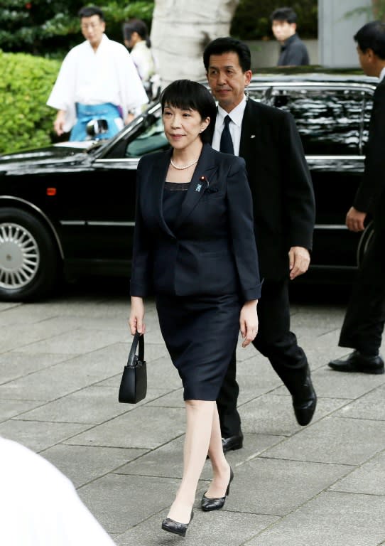 Japan's internal affairs minister Sanae Takaichi (centre) visits the controversial Yasukuni shrine in Tokyo, on October 19, 2016