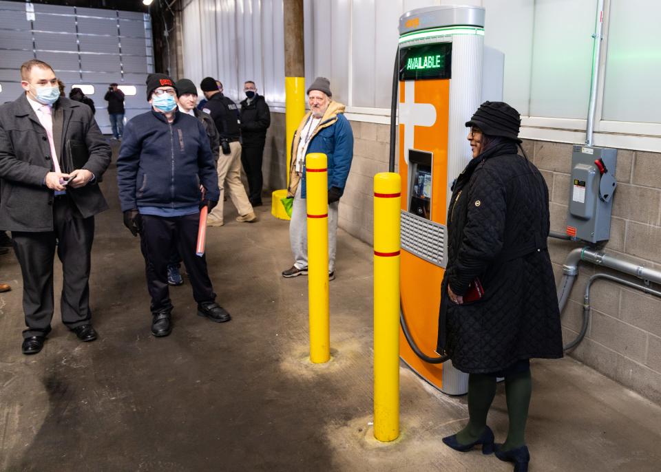 Summit County Council District 5 Representative Veronica Sims takes a photo next to one of the Chargepoint Charging Stations in METRO’s bus garage Tuesday in Akron.