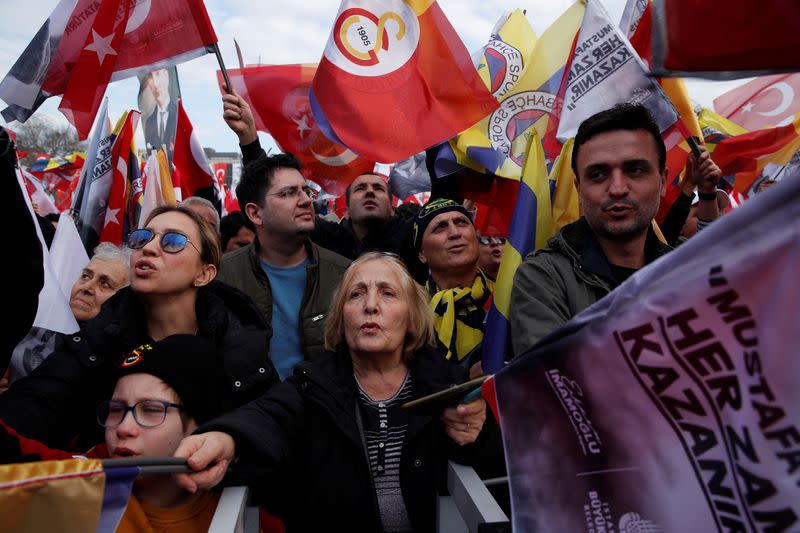 People wave flags in support of Turkish soccer teams Fenerbahce and Galatasaray during a gathering in Istanbul