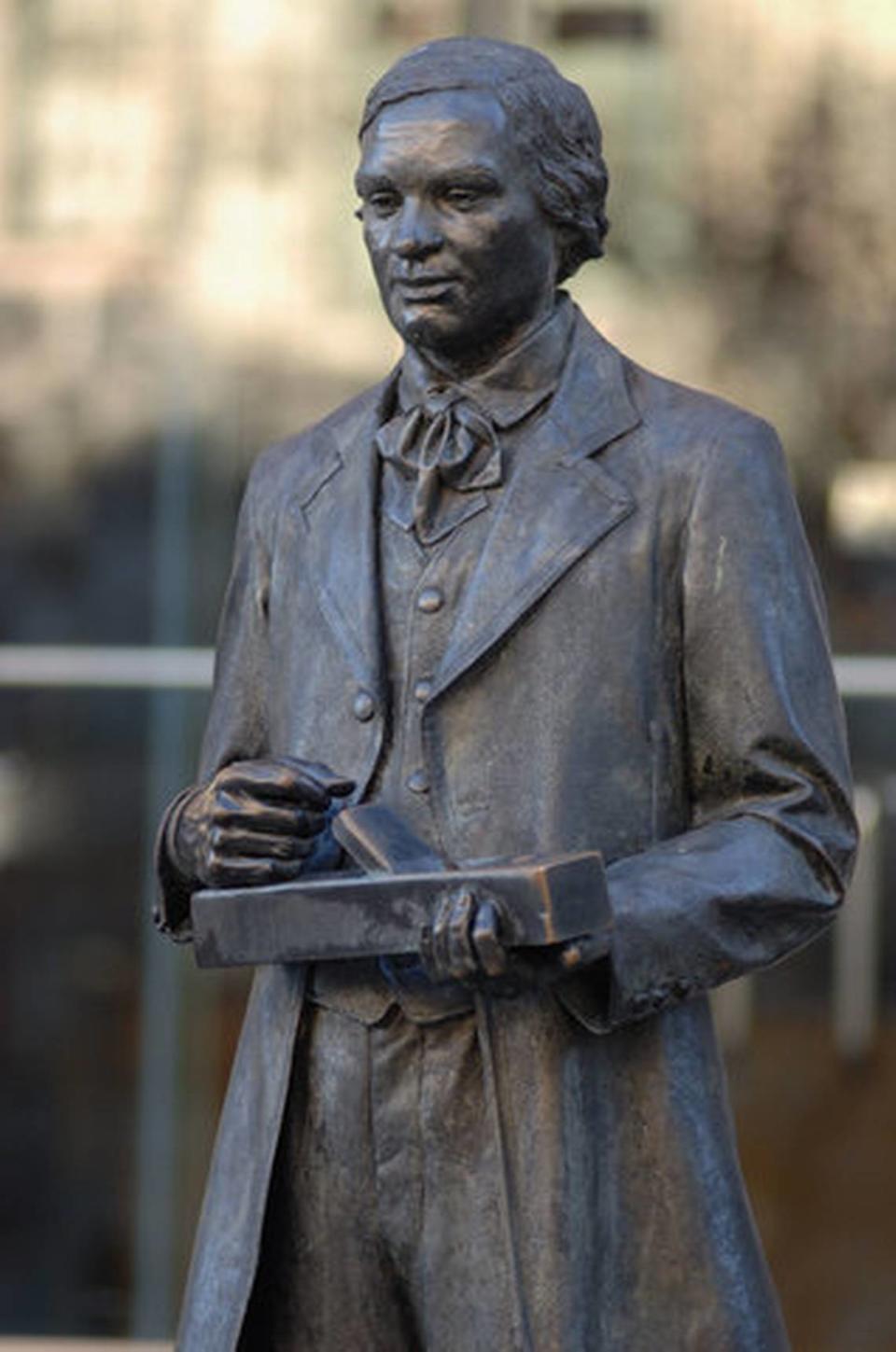 A statue of 19th century furniture maker Thomas Day stands outside the N.C. Museum of History in Raleigh.