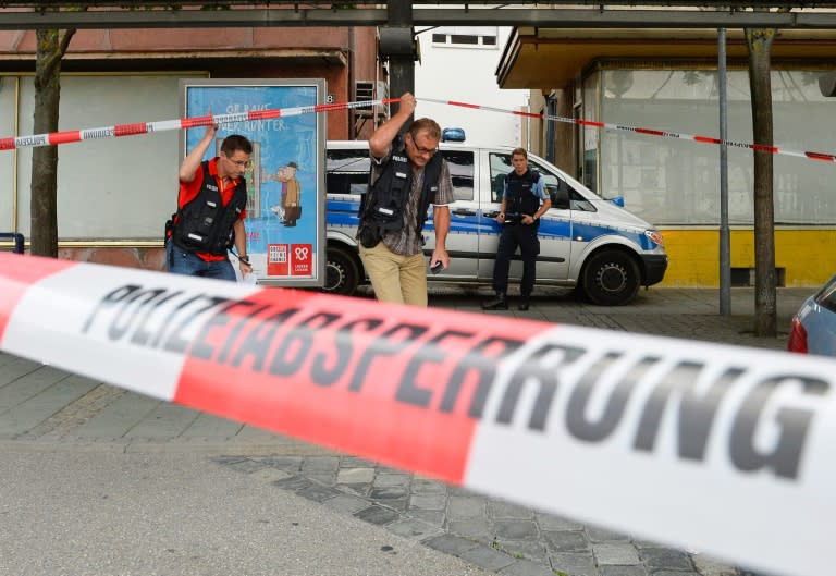 Police officers investigate the site near a fastfood restaurant in Reutlingen, southwestern Germany, on July 24, 2016 where a Syrian asylum-seeker killed a woman and injured two people with a machete