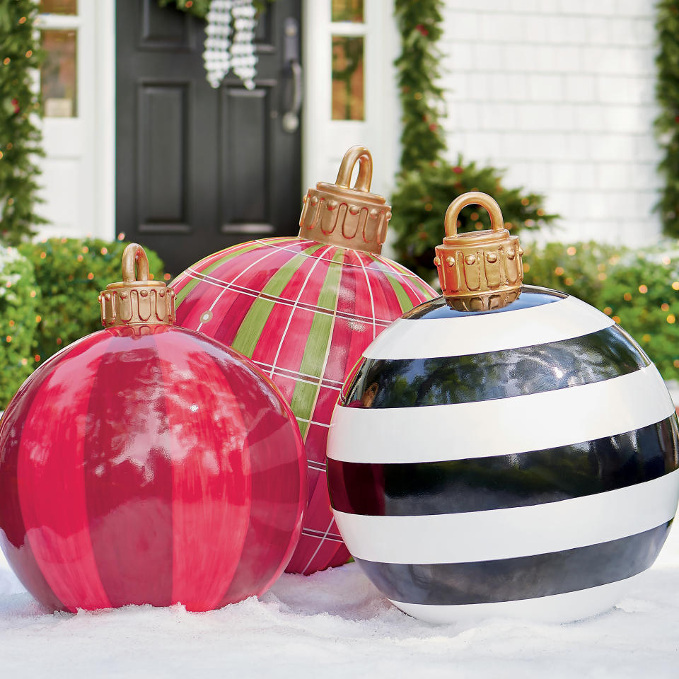 This image provided by Grandin Road shows their oversized fiberglass ornaments. The ornaments are whimsical and eye-catching. Kids can imagine they've fallen off a giant's Christmas tree, and adults can enjoy the bold, statement-making patterns. www.grandinroad.com (Grandin Road via AP)