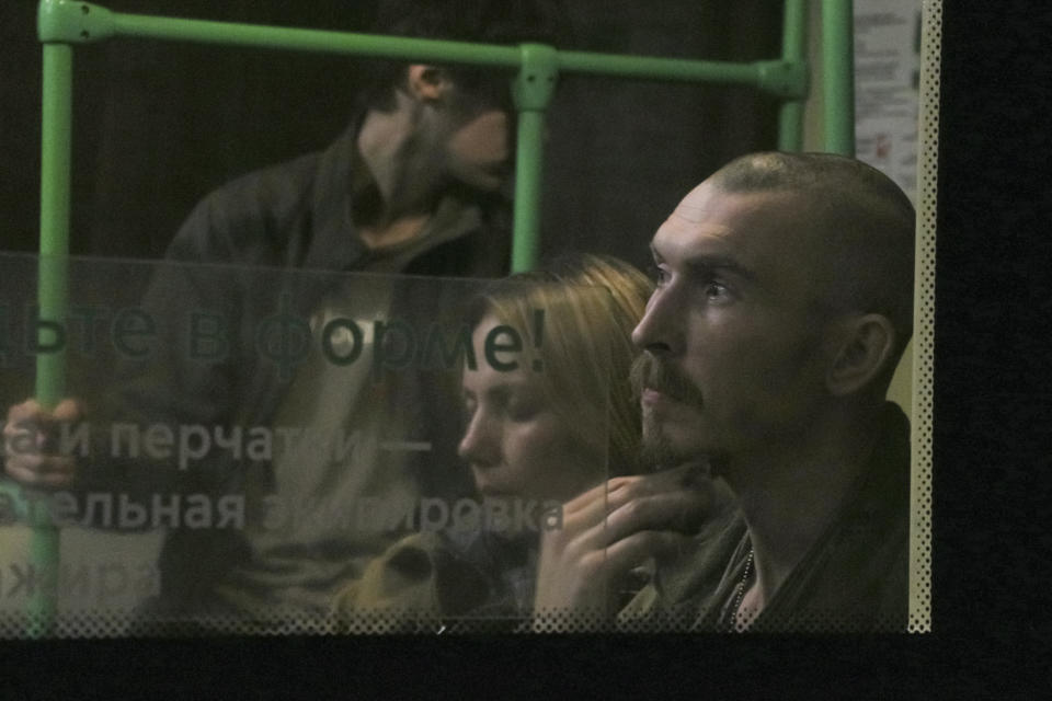 Ukrainian servicemen sit in a bus after they were evacuated from the besieged Mariupol's Azovstal steel plant, near a prison in Olyonivka, in territory under the government of the Donetsk People's Republic, eastern Ukraine, Tuesday, May 17, 2022. More than 260 fighters, some severely wounded, were pulled from a steel plant on Monday that is the last redoubt of Ukrainian fighters in the city and transported to two towns controlled by separatists, officials on both sides said. (AP Photo)