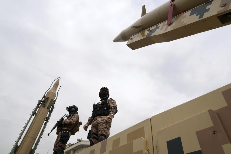 Iran's Revolutionary Guard members protect "Shahab-3", left, and "Khaibar-buster" missiles which are displayed during the annual pro-Palestinians Al-Quds, or Jerusalem, Day rally in Tehran, Iran, Friday, April 29, 2022. Iran does not recognize Israel and supports Hamas and Hezbollah, militant groups that oppose it. (AP Photo/Vahid Salemi)