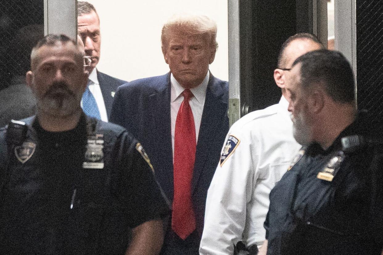 Donald Trump arrives in court for his arraignment proceeding at Manhattan Criminal Court on April 4, 2023, in New York City. His trial begins April 15, 2024.