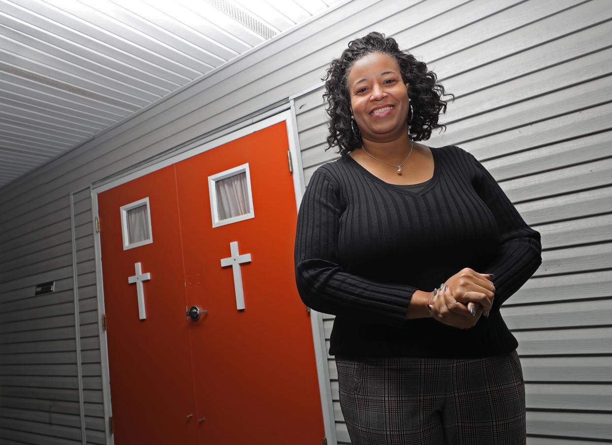 Pastor Shiloh Hooks-Johnson stands for a portrait Wednesday outside Kingdom Restoration Church at 181 Burton Ave. in Akron's Highland Square neighborhood.