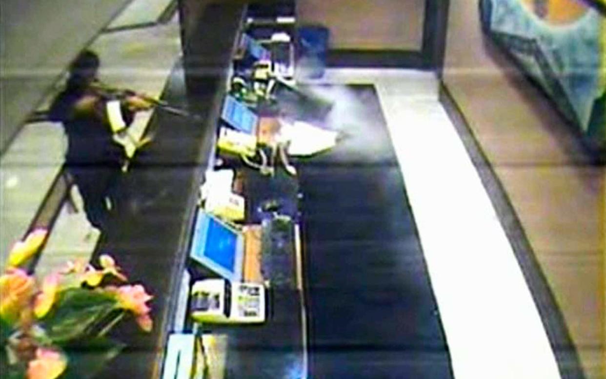 CCTV showed a gunman, dressed in black, shooting at the front desk of Mumbai's Trident hotel