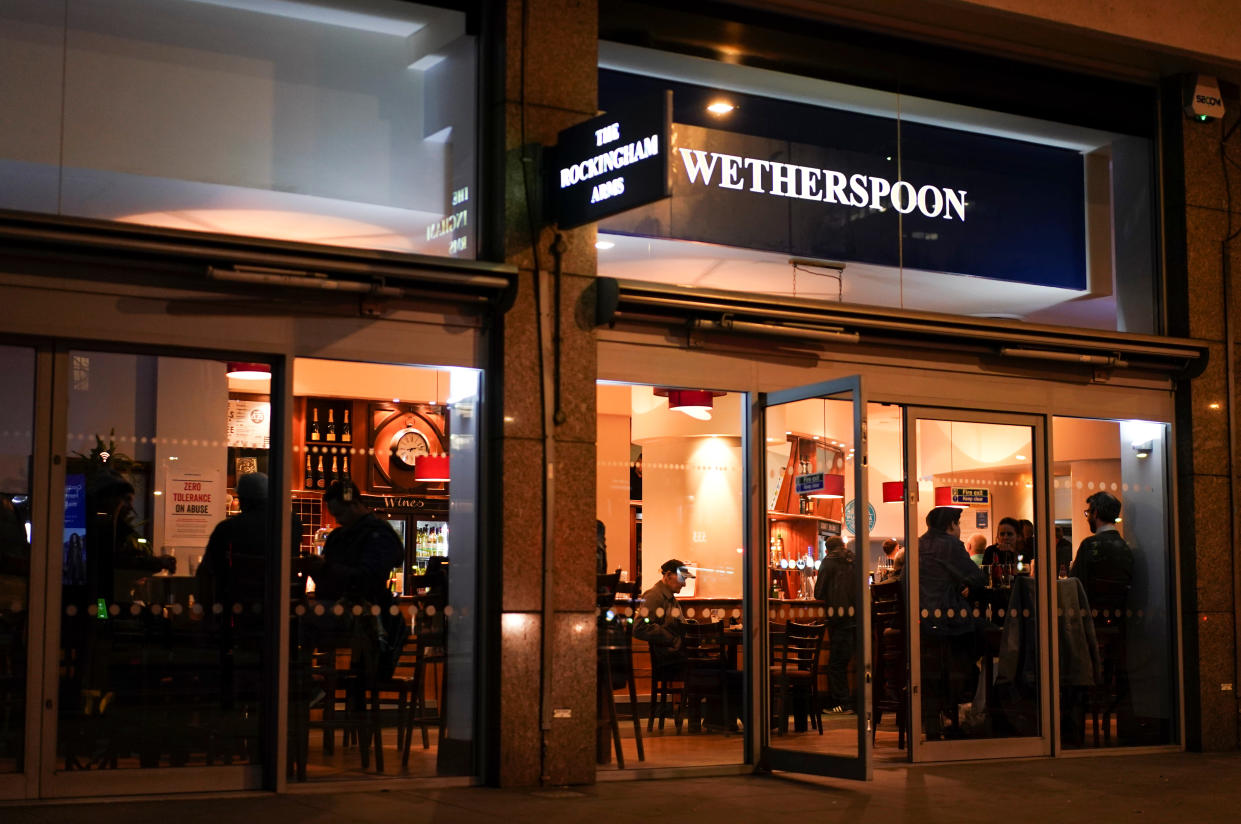 People are seen inside a Wetherspoon pub, on the day Prime Minister Boris Johnson ordered all pubs to close in response to the number of the coronavirus disease (COVID-19) cases continuing to grow, in London, Britain, March 20, 2020. REUTERS/Henry Nicholls