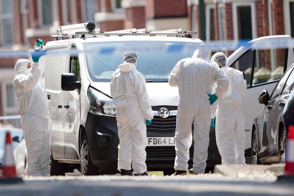 Police forensics officers search a white van on the corner of Maples Street and Bentinck Road in Nottingham, as three people have been found dead in the city in what police described as a 