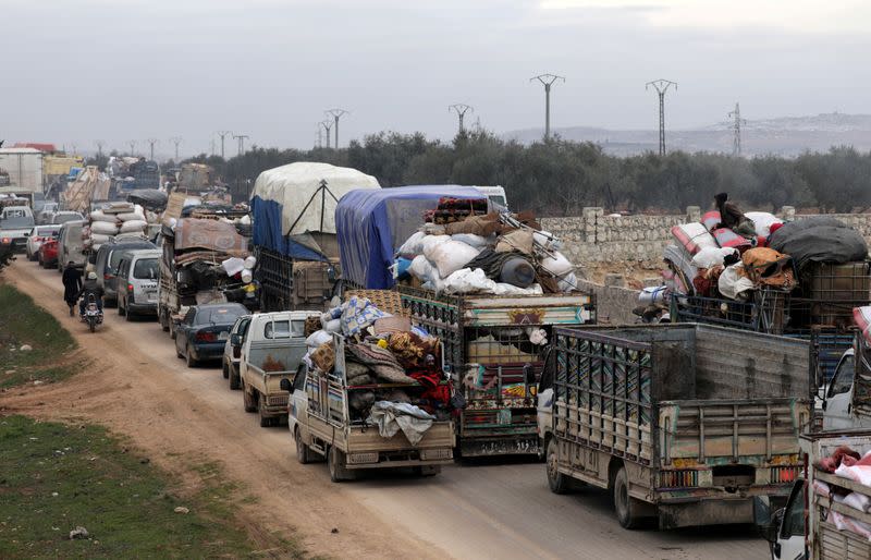 FILE PHOTO: A general view of vehicles carrying belongings of internally displaced Syrians from western Aleppo countryside, in Hazano near Idlib