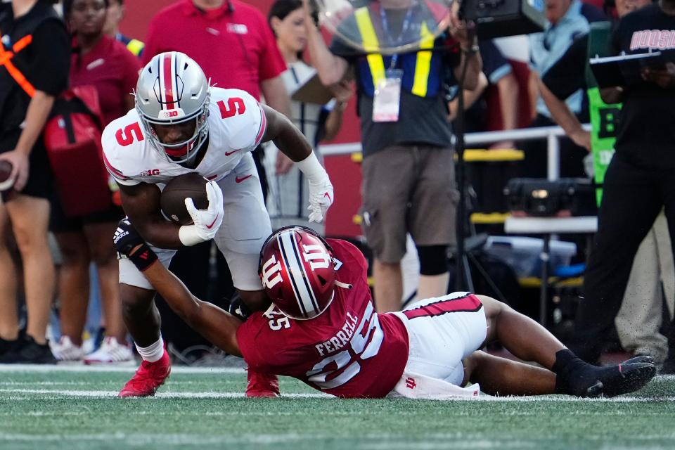Sep 2, 2023; Bloomington, Indiana, USA; Ohio State Buckeyes running back Dallan Hayden (5) is tackled by Indiana Hoosiers defensive back Amare Ferrell (25) during the NCAA football game at Indiana University Memorial Stadium. Ohio State won 23-3.