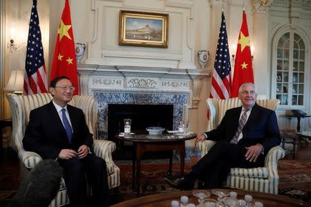 Secretary of State Rex Tillerson greets Chinese State Councilor Yang Jiechi at the State Department in Washington, U.S., February 28, 2017. REUTERS/Aaron P. Bernstein - RTS10SK4