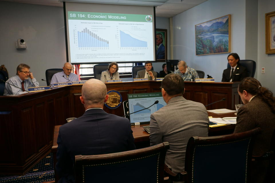 Officials with the Alaska Division of Oil and Gas, testifying at an April 26 hearing of the Senate Resources Committee, present their economic case to for reduced royalties on new Cook Inlet production. Speaking to the committee are, from left, Derek Nottingham, the division's director, Jhonny Meza, an economist and commercial manager for the division, and John Crowther, deputy commissioner of the Department of Natural Resources. (Photo by Yereth Rosen/Alaska Beacon)