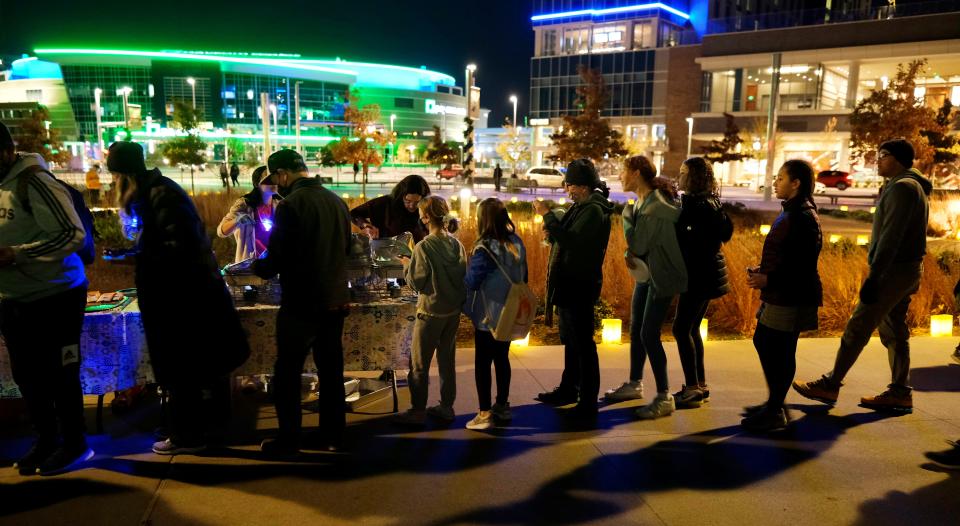 People line up to get a taste of Hanukkah treats like latkes during "Scissortail Lights," a community Hanukkah celebration at Scissortail Park's Love's Travel Stops Stage and Great Lawn in downtown Oklahoma City.