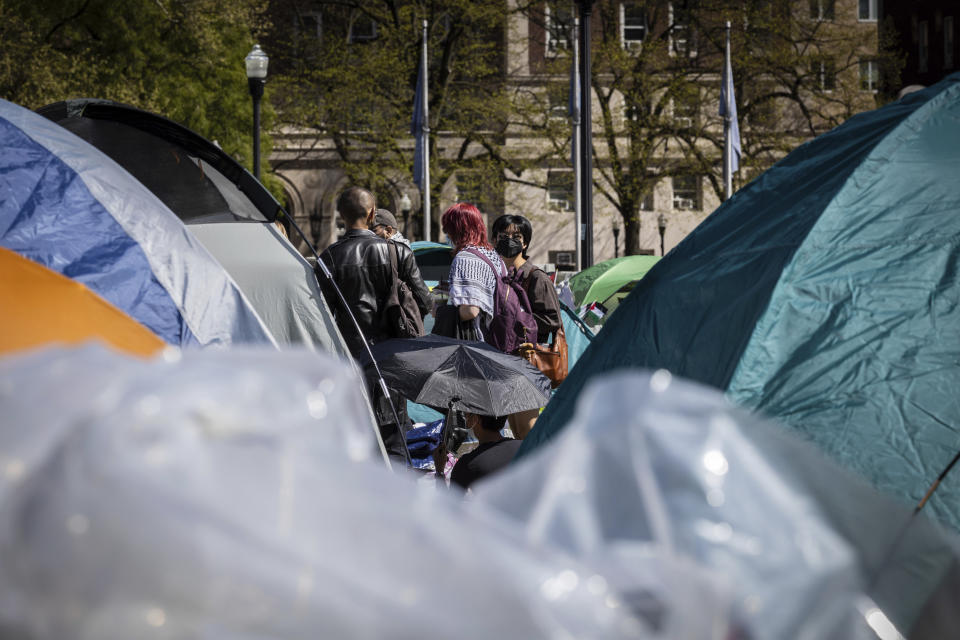 A student protester sits among the tents erected at the Pro-Palestinians protest at the Columbia University campus in New York on Monday April 22, 2024. (AP Photo/Stefan Jeremiah)