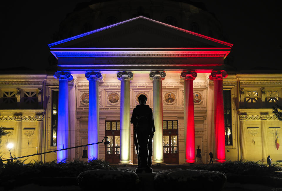 The Romanian Atheneum concert hall, the venue for an event marking the official start of the Romanian Presidency of the Council of the European Union, is illuminated in the colors of the country's flag in Bucharest, Romania, Thursday, Jan. 10, 2019. (AP Photo/Vadim Ghirda)