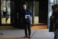 Dutch-Palestinian Ismail Ziada, center, and his lawyer Liesbeth Zegveld, rear left, leave the court building after a Dutch appeals court in The Hague Tuesday, Dec. 7, 2021, upheld a lower court's decision to throw out a civil case against Israel's defense minister and another former senior military officer over their roles in a deadly 2014 airstrike in Gaza which killed six members of the Ziada family. (AP Photo/Peter Dejong)