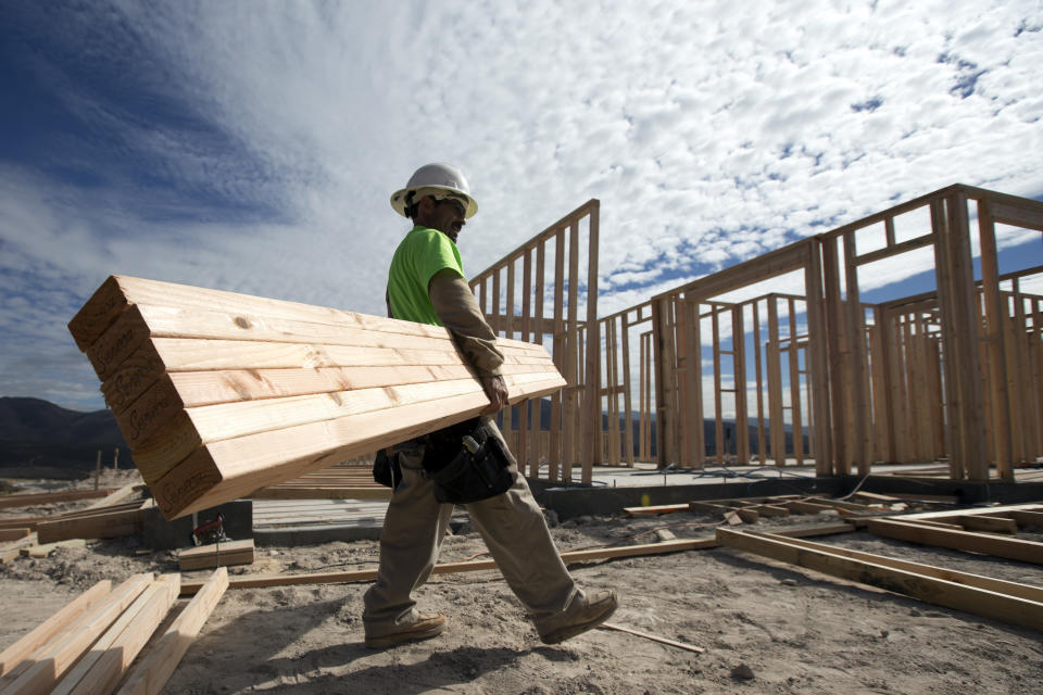 In this Friday, Nov. 16, 2012, photo, construction worker Miguel Fonseca carries lumber as he works on a house frame for a new home  in Chula Vista, Calif. Confidence among U.S. homebuilders inched up in Novemeber to the highest level in more than six and a half years, as builders reported the best market for newly built homes since the housing boom.(AP Photo/Gregory Bull)