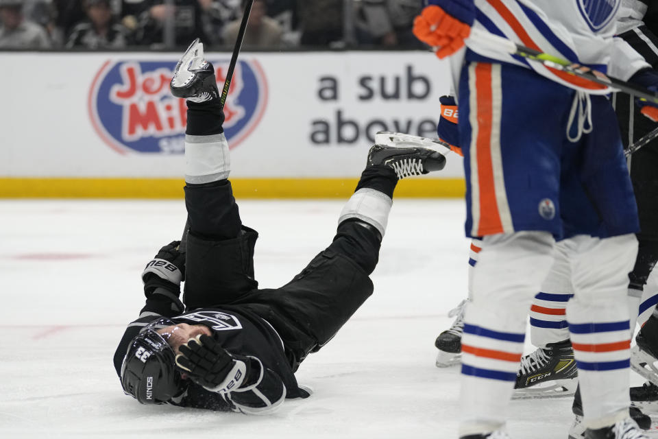Los Angeles Kings right wing Viktor Arvidsson (33) falls after being pushed by Edmonton Oilers defenseman Mattias Ekholm during the second period of Game 4 of an NHL hockey Stanley Cup first-round playoff series hockey game Sunday, April 23, 2023, in Los Angeles. (AP Photo/Ashley Landis)