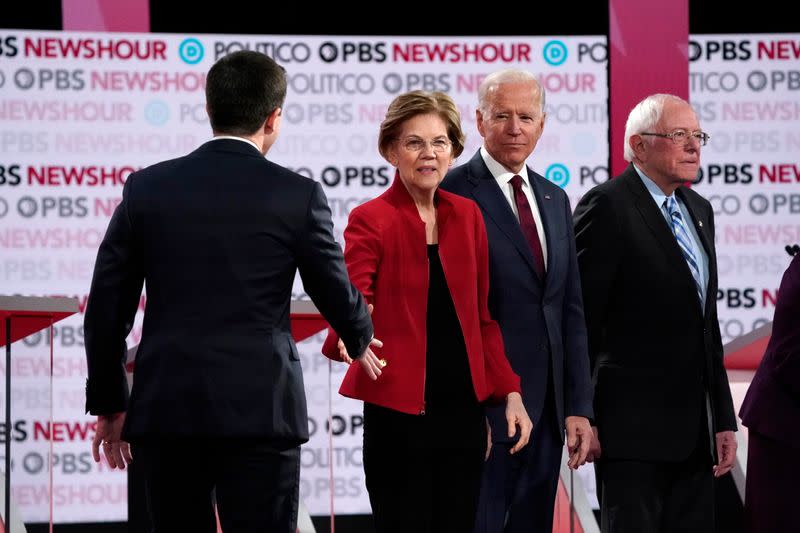 Candidates Buttigieg, Warren, Biden and Sanders at the start of the sixth 2020 U.S. Democratic presidential candidates campaign debate at Loyola Marymount University in Los Angeles, California, U.S.