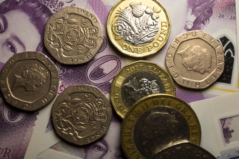 UNITED KINGDOM - 2020/06/06: In this photo illustration banknotes of the pound sterling, The Bank of England £20 notes with the image of Queen Elizabeth II and various coins of the pound sterling are seen displayed. (Photo Illustration by Karol Serewis/SOPA Images/LightRocket via Getty Images)