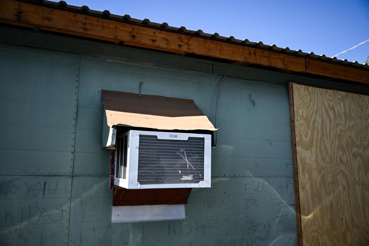 <span>An air-conditioning unit in a home during a record heatwave in Phoenix, Arizona, on 19 July 2023.</span><span>Photograph: Patrick T Fallon/AFP via Getty Images</span>