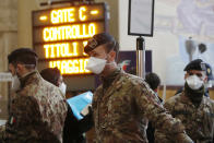 Police officers and soldiers check passengers leaving from Milan main train station, Italy, Monday, March 9, 2020. Italy took a page from China's playbook Sunday, attempting to lock down 16 million people — more than a quarter of its population — for nearly a month to halt the relentless march of the new coronavirus across Europe. Italian Premier Giuseppe Conte signed a quarantine decree early Sunday for the country's prosperous north. Areas under lockdown include Milan, Italy's financial hub and the main city in Lombardy, and Venice, the main city in the neighboring Veneto region. (AP Photo/Antonio Calanni)