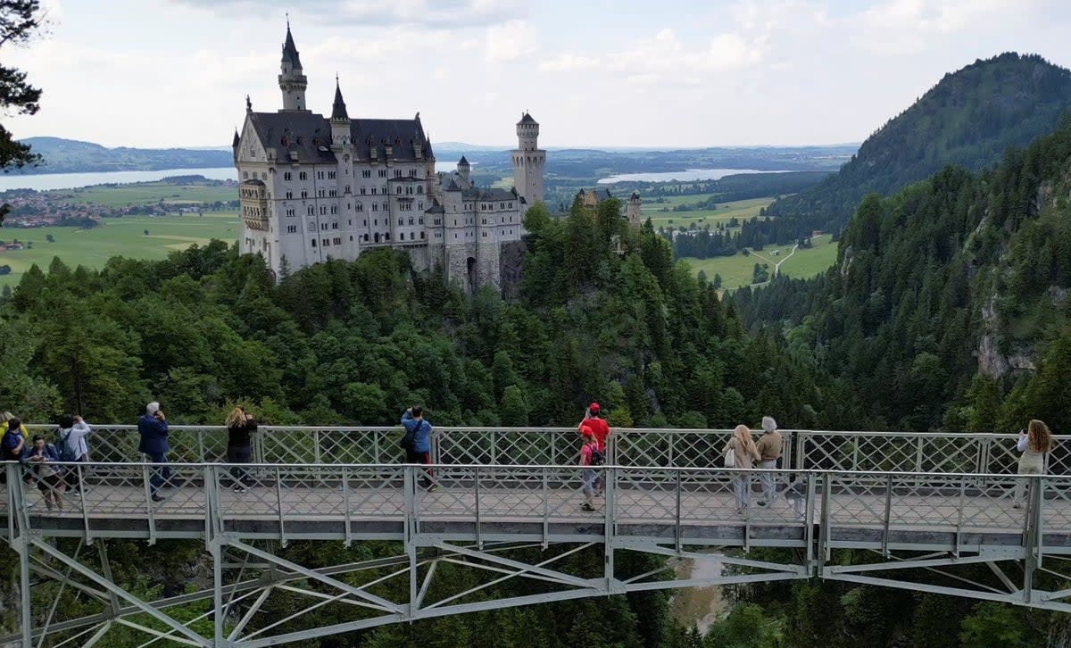 Tourists on the Marienbrücke bridge overlooking Neuschwanstein Castle  (REUTERS)