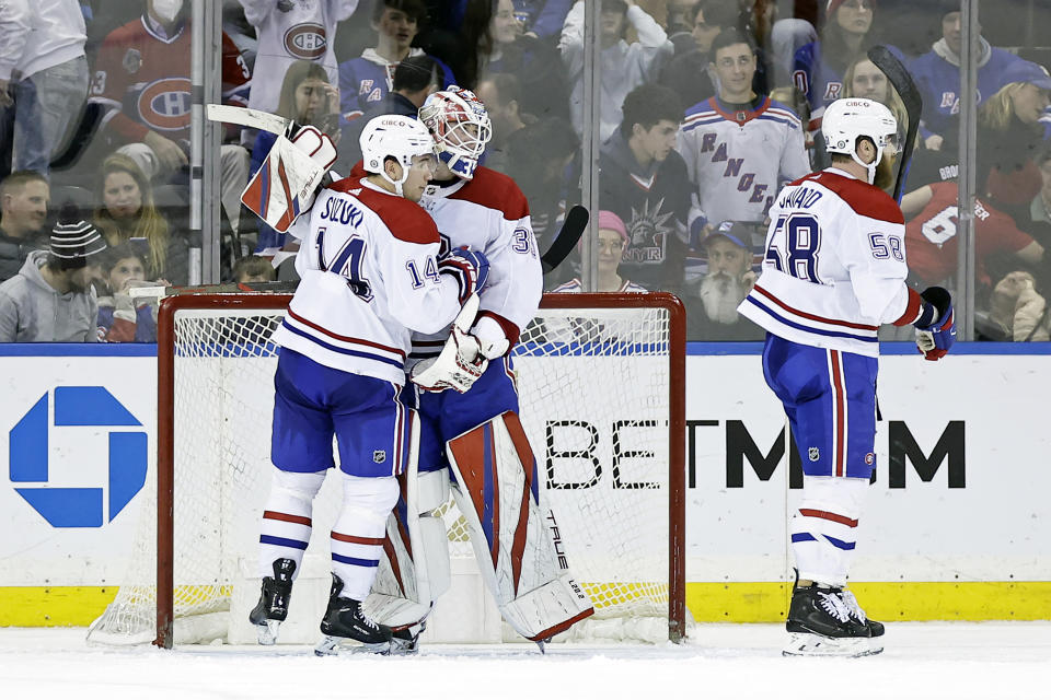 Montreal Canadiens goaltender Sam Montembeault (35) celebrates with Nick Suzuki (14) after defeating the New York Rangers in an NHL hockey game Sunday, Jan. 15, 2023, in New York. (AP Photo/Adam Hunger)