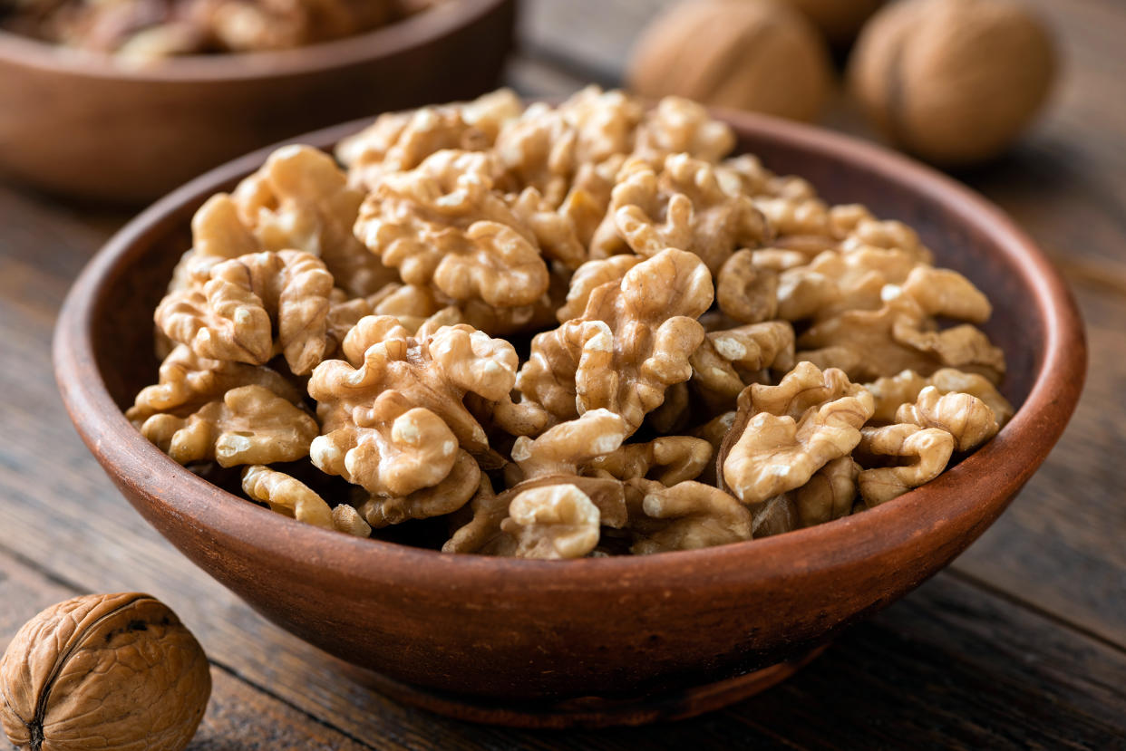 Walnuts in brown bowl. (Getty Images)